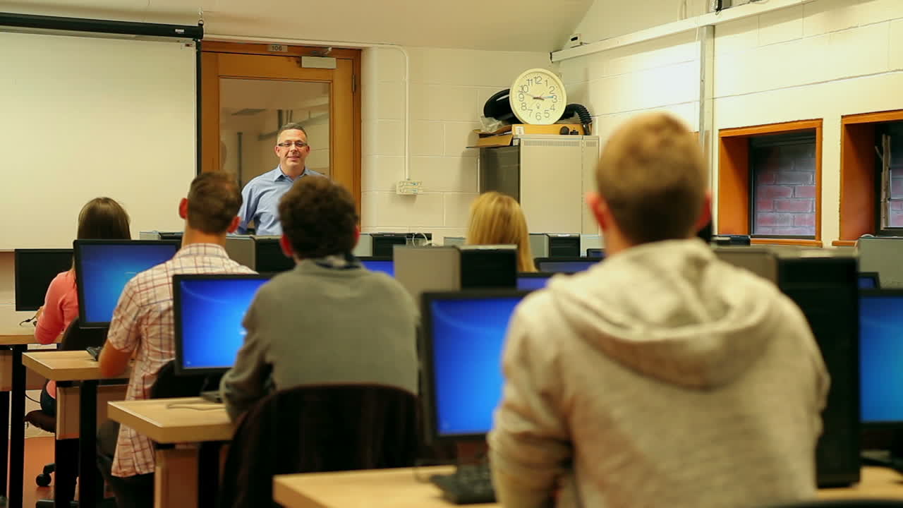 Students listening to lecturer in computer room
