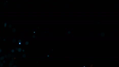 volar pequeñas partículas azules y doradas con humo oscuro