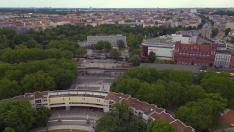 Majestic-aerial-top-view-flight-Ghetto-Building-Mehringplatz-place-city-Berlin-steglitz,-Germany-Summer-day-2023