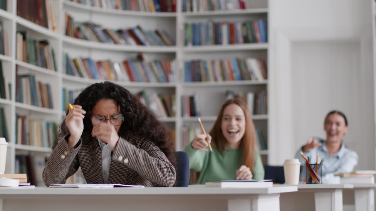 Student Struggling to Concentrate Amidst Noisy Peers in a Library
