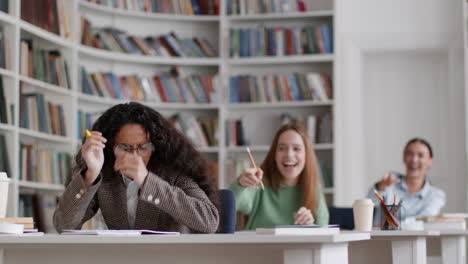 student struggling to concentrate amidst noisy peers in a library