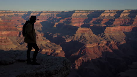 person at the grand canyon sunrise