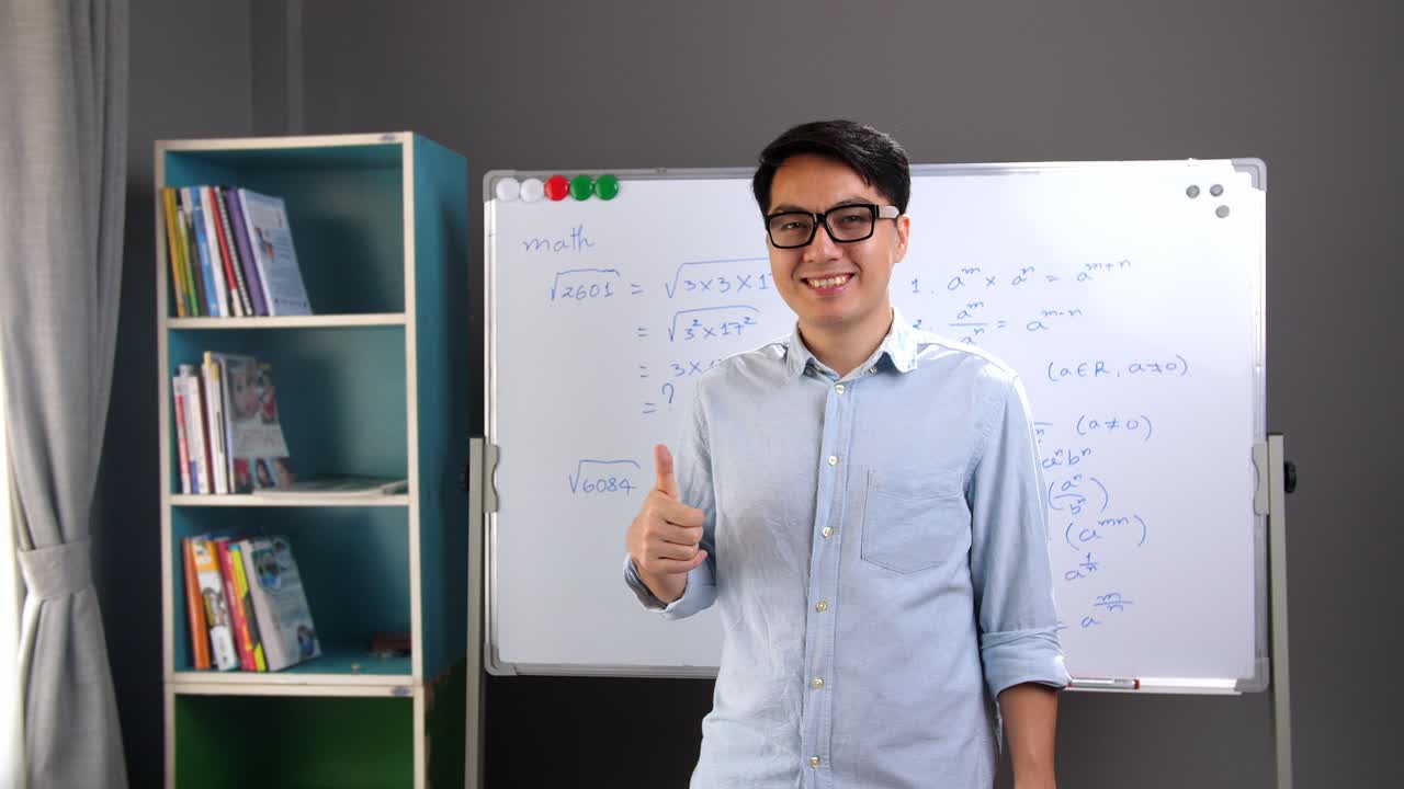 Male Asian Teacher Making A Thumb Up