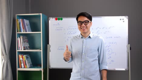 male asian teacher making a thumb up