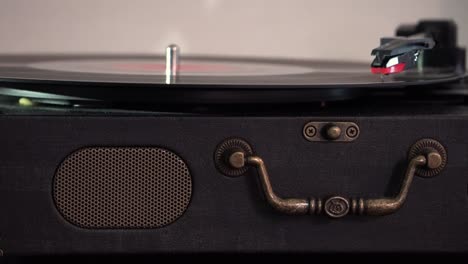 listening to music on a vintage suitcase record player