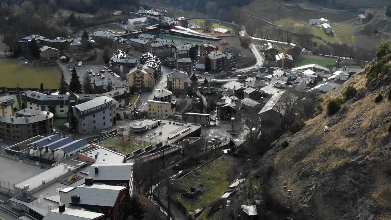 Aerial view of Andorran mountain town with surrounding valley and peaks. Scenic Pyrenees, European travel, establishing shot for alpine setting
