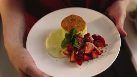 close up of a biscuit and strawberries on a plate