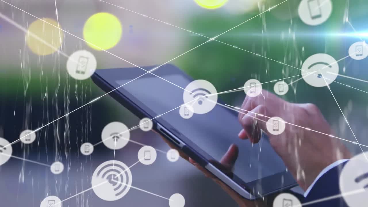 Animation of network of connections with icons over caucasian businessman using tablet