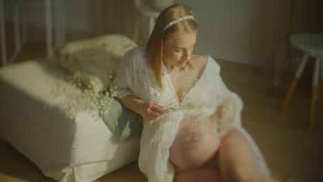 pregnant woman relaxing with flowers