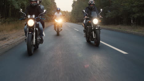 A-group-of-bikers-rides-along-the-highway-in-a-row