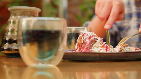 person eating a dessert outdoors