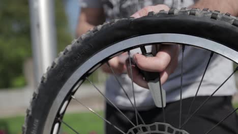man repairing his bicycle tire