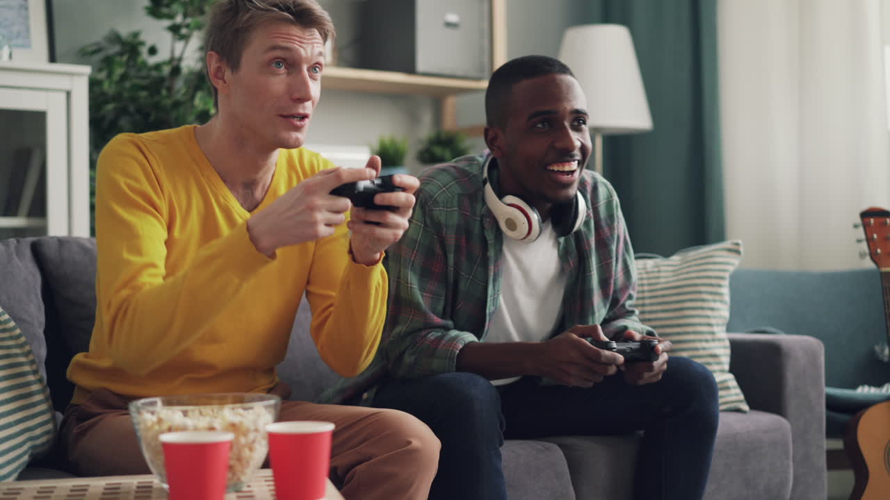 Two friends enjoying a video game session at home