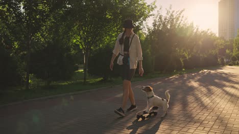 woman skateboarding with her dog in a park