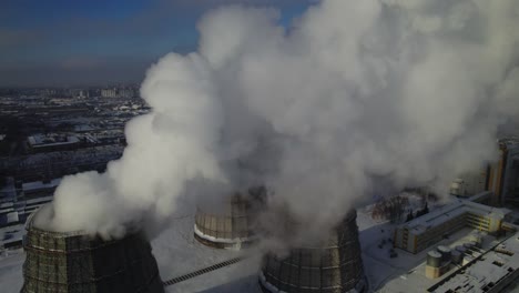 aerial view of power plant with smoke in winter