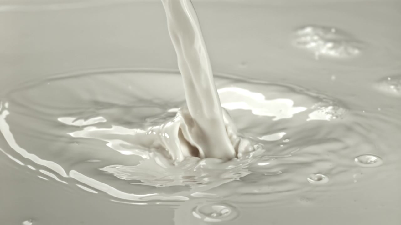 Fresh Milk Pouring and Creating Splashes in Slow Motion