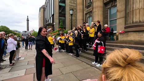 choir singing on steps, audience watching