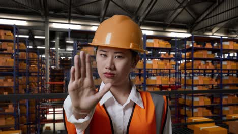 warehouse worker gesturing stop