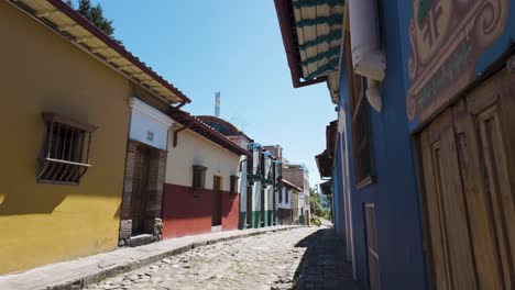 typical cobblestone street with graffiti from la candelaria district, bogota, colombia