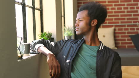 smiling african american man by window