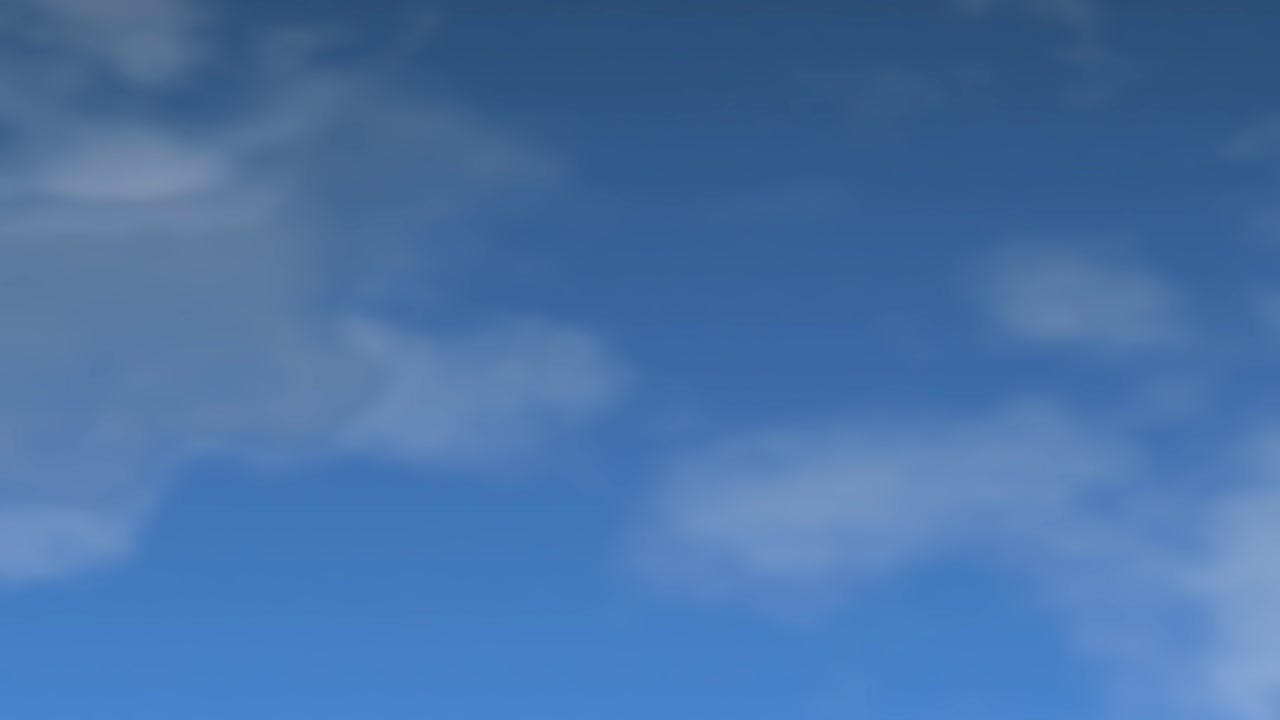 Nuvole bianche e leggere fluttuano lentamente in un cielo azzurro, che si trasforma in un'atmosfera notturna scura.