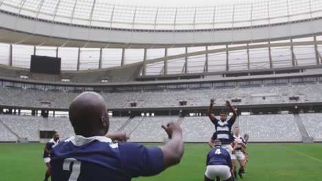 Male-rugby-players-playing-rugby-match-in-stadium-4k