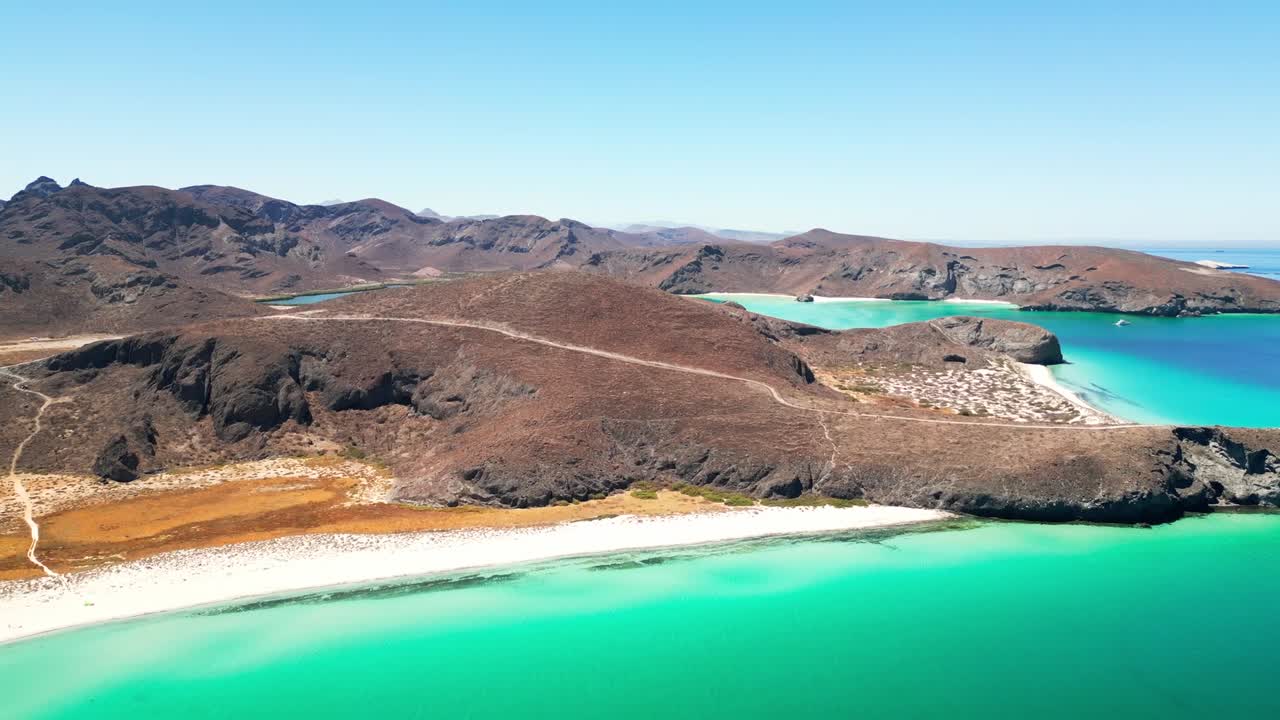 Breathtaking aerial view of Tecolotito Beach, La Paz, with turquoise waters and rugged hills