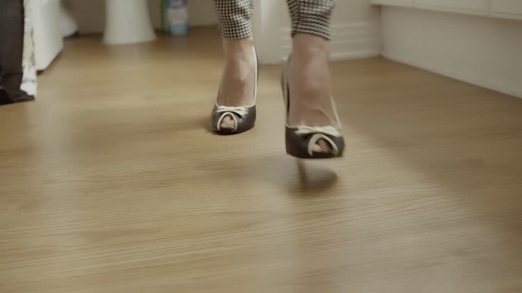Close-up of a woman's feet stepping in peep toe black and white shoes
