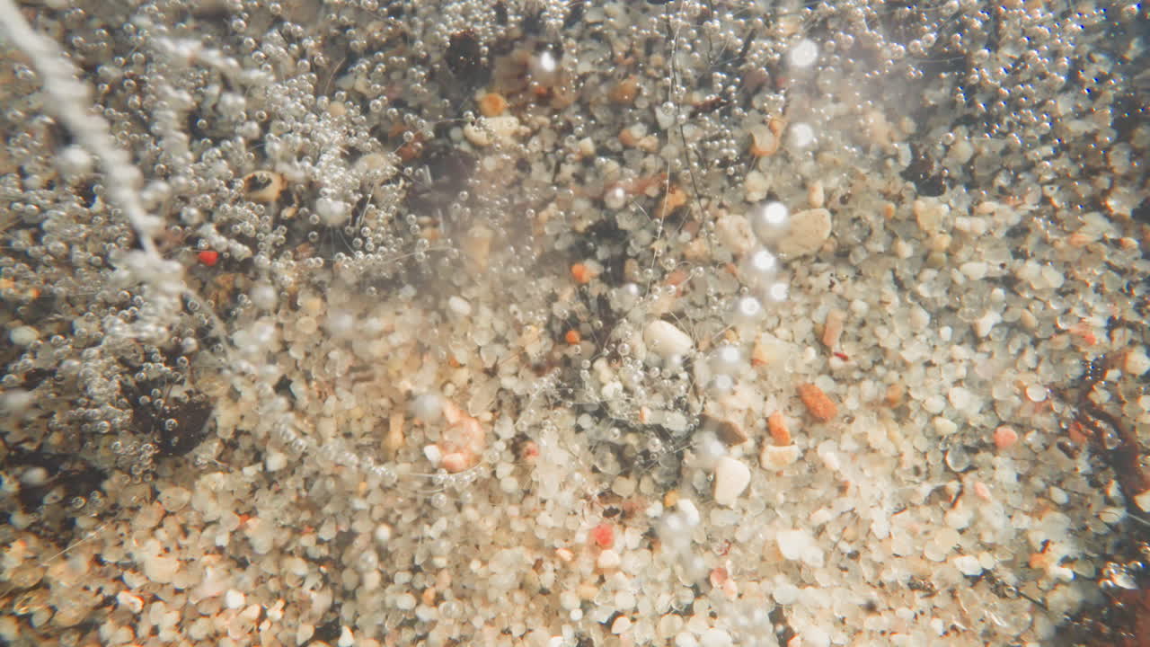 물의 흐름은 밝은 색의 자갈과 공기 거품을 움직입니다.