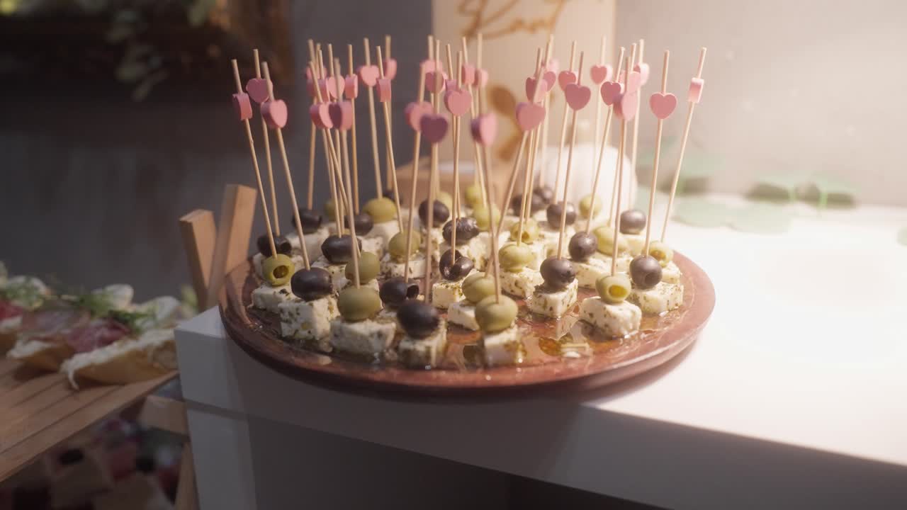 Canapes for celebrations and parties. Selected cheeses with olives as snacks for guests