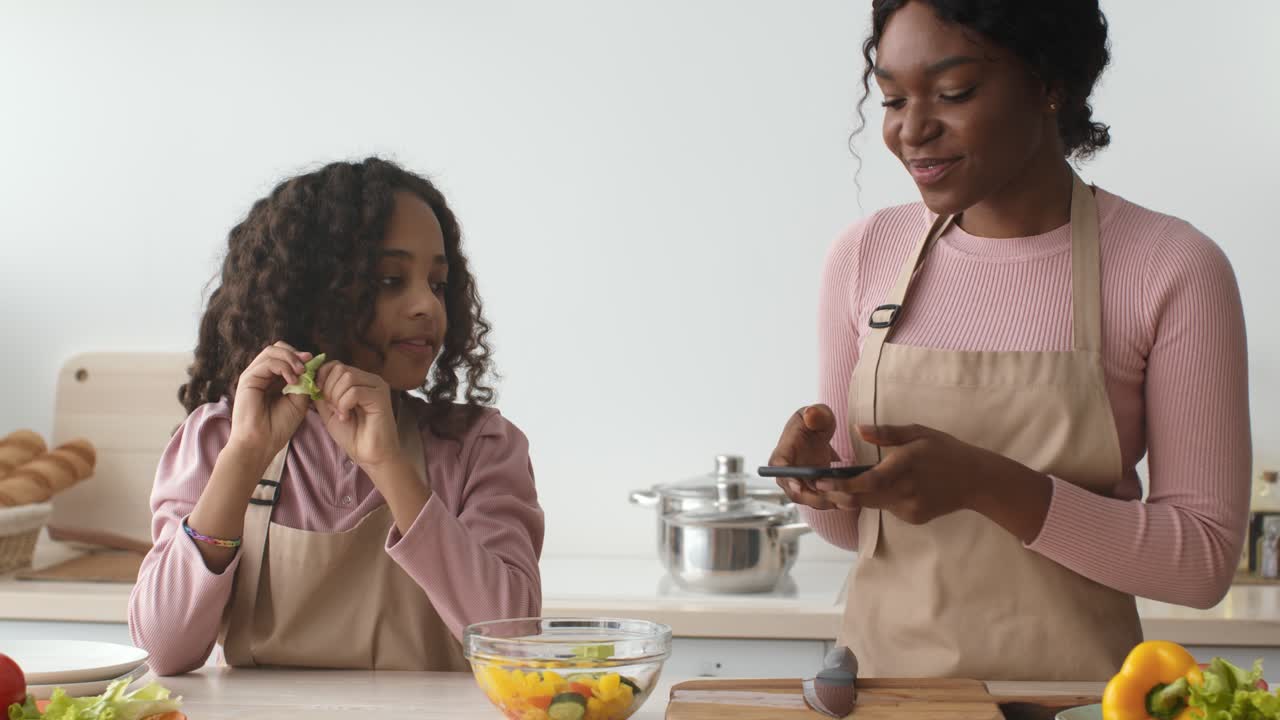 Mother and daughter preparing a healthy salad together