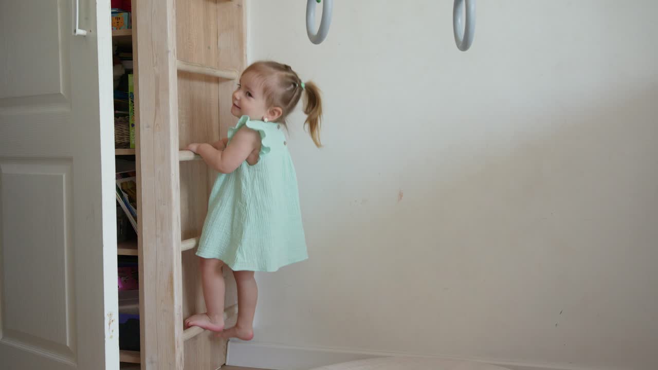 Cute Toddler Girl Climbing Wooden Ladder in Playroom