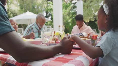 happy family eating together at table