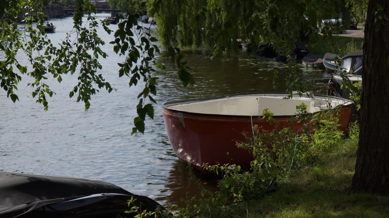 Boats On Canal In Amsterdam, Netherlands - Wide Shot