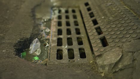 dirty street drain at night