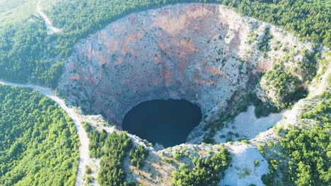 Descripción-Aérea-Alrededor-Del-Lago-Rojo-En-La-Soleada-Imotski,-Croacia