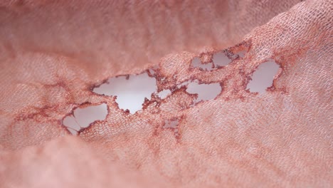 close-up of a torn piece of pink fabric