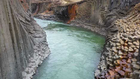 fast streaming water through a canyon in iceland