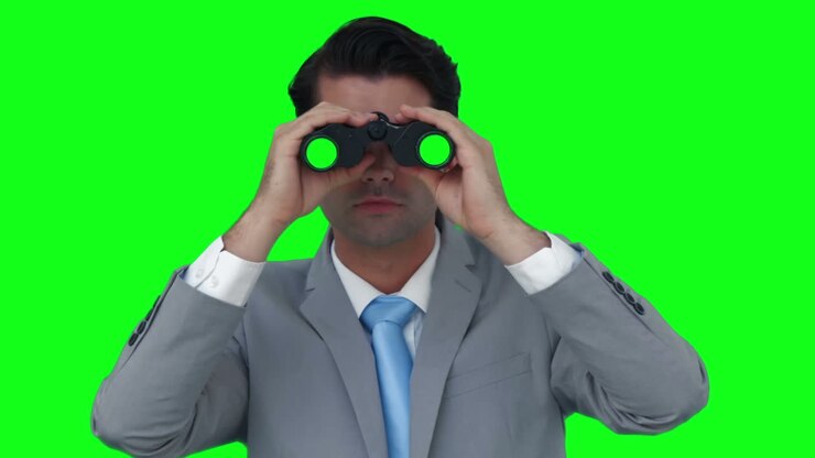 Businessman looking through binoculars
