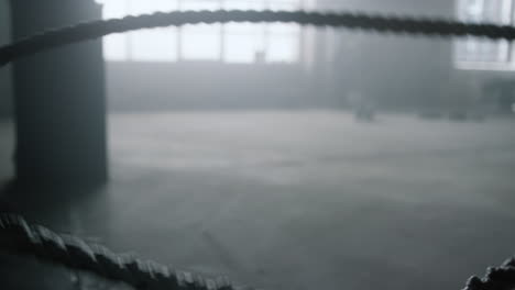 athlete working with battle ropes. woman practicing crossfit exercise