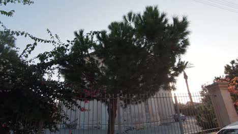 Sunset-cloaking-over-golden-light-the-Church-of-the-Holy-Trinity-in-Limassol-center,-Cyprus---Wide-slide-right-to-left-shot