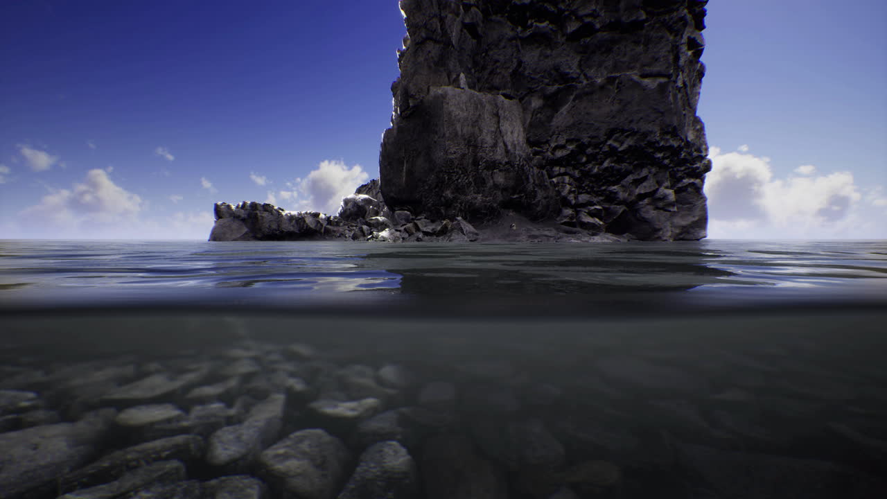 Exploring a rocky shoreline under a bright blue sky by calm waters