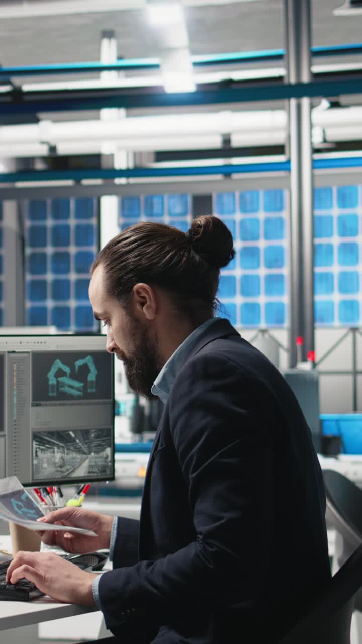 Vertical Video Professional inspector reviewing manufacturing process data on computer