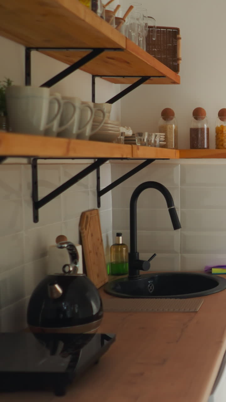 Kitchen with utensils in glamping hotel. Light room with decorative elements for comfortable stay for tourists. Review of accommodation for rent for visitors