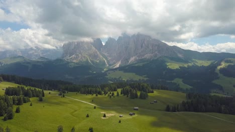 reveal aerial of the dolomites mountains at alpe di siusi, ortisei, italia