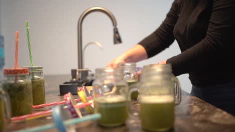 young latin girl prepare cocktail mocktail or smoothie at her kitchen