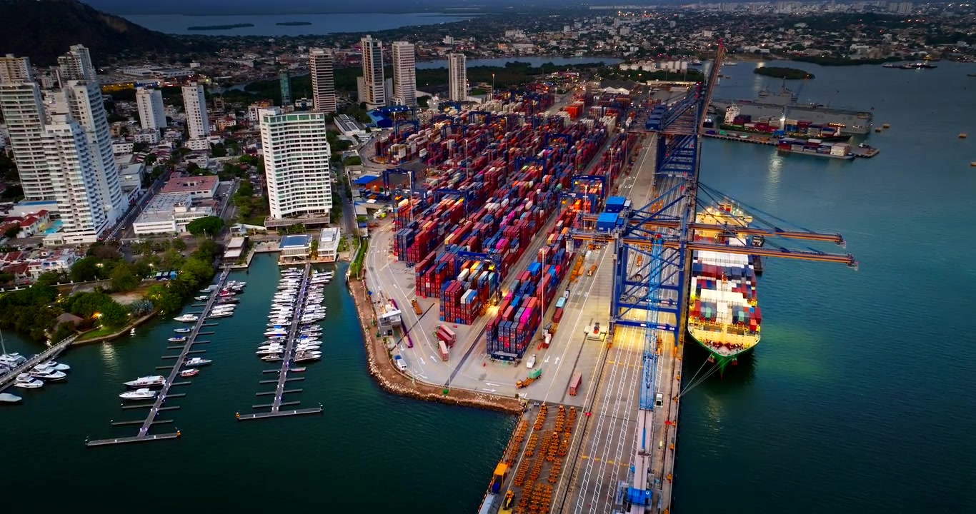 Aerial view over Cartagena port with stacked containers and cranes, Colombia