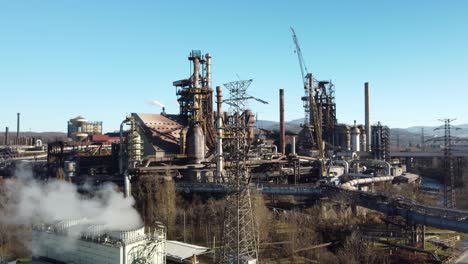 steel works factory with smoke emissions from chimneys