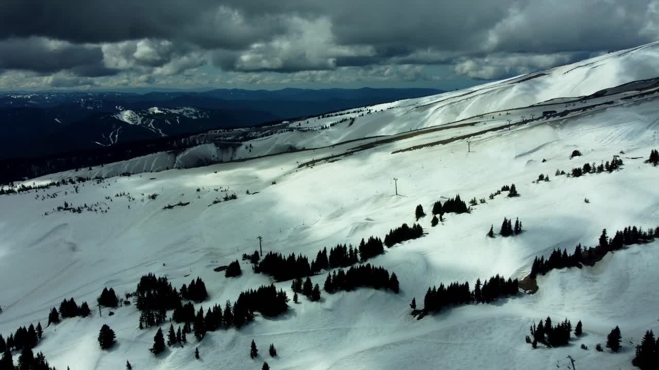 US, Oregon, Mt Hood, Meadows Ski Area, 2025-04-22 - Drone view of Mt Hood at the Mt Hood Meadows ski area in spring. Flying across the ski runs and lifts towards Timberline.