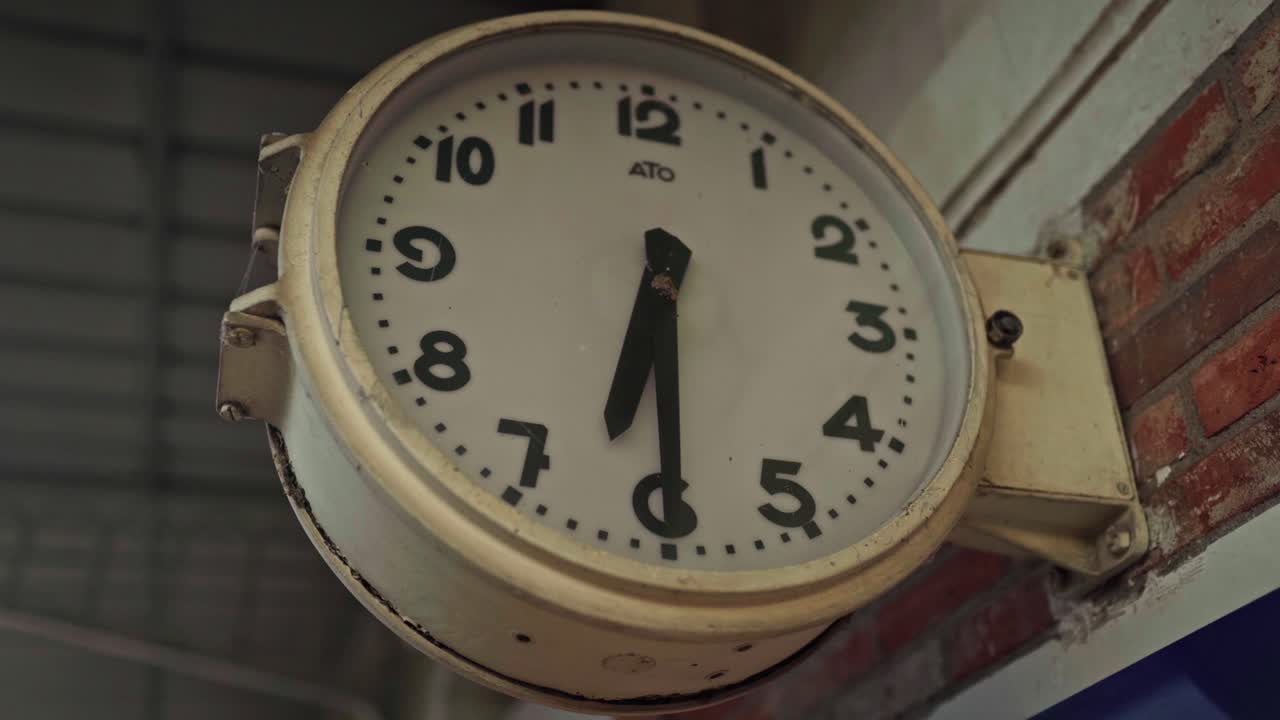 Railway station clock strikes six thirty